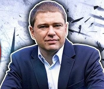 Piotr Szumlewicz przemawiający z pasją na wiecu związkowym lub debacie publicznej, aktywnie gestykulujący, na tle zaangażowanego tłumu, symbolizujący jego zaangażowanie w walkę o prawa pracownicze i sprawiedliwość społeczną.